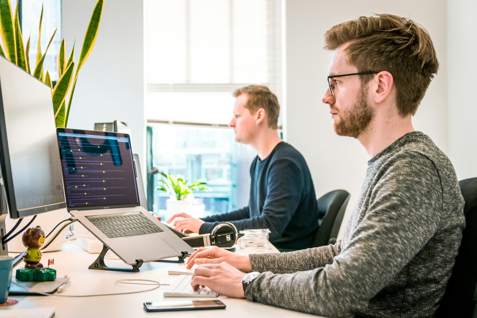 Two developers coding in an office